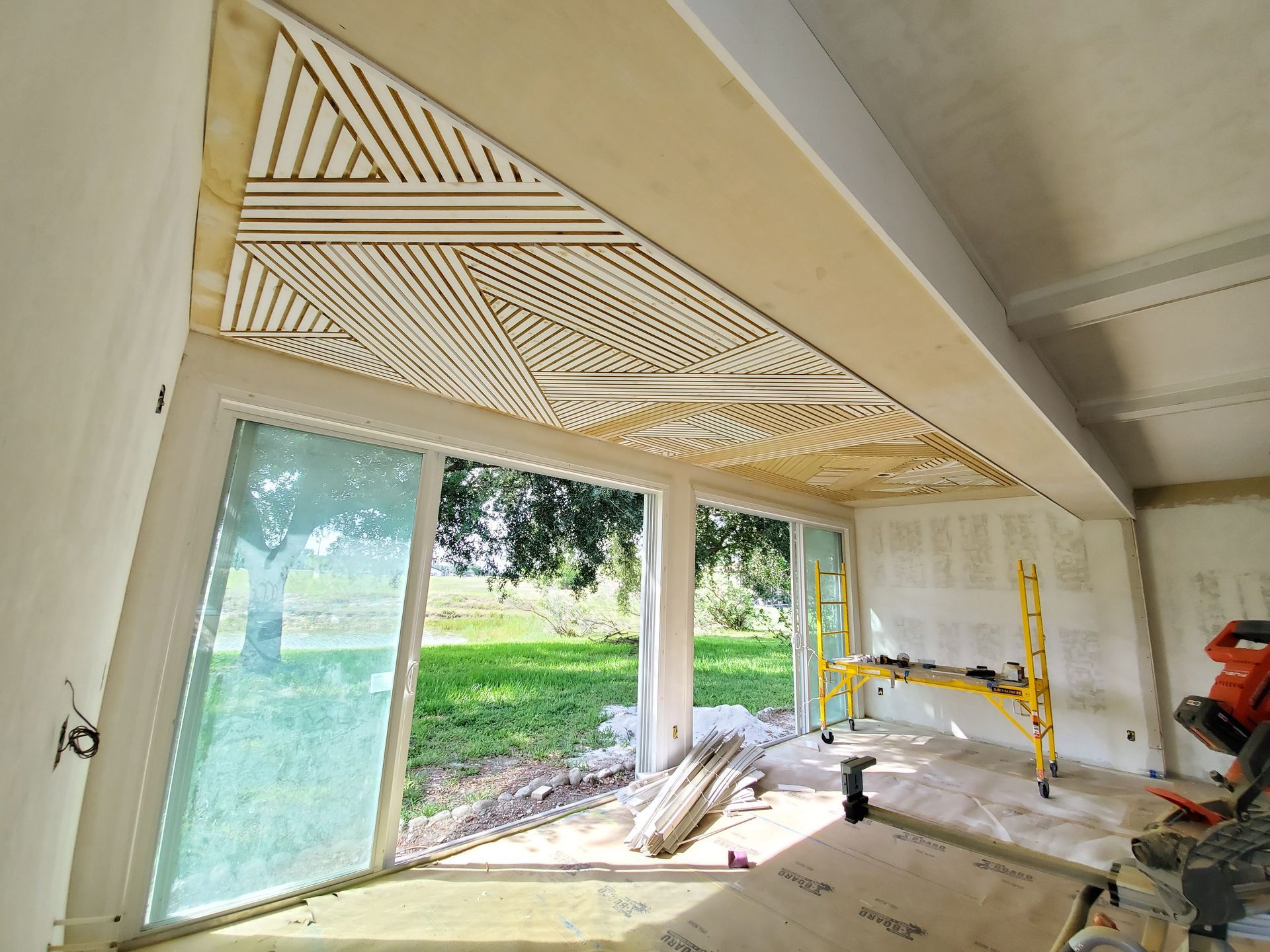 A room with a lot of windows and a wooden ceiling.