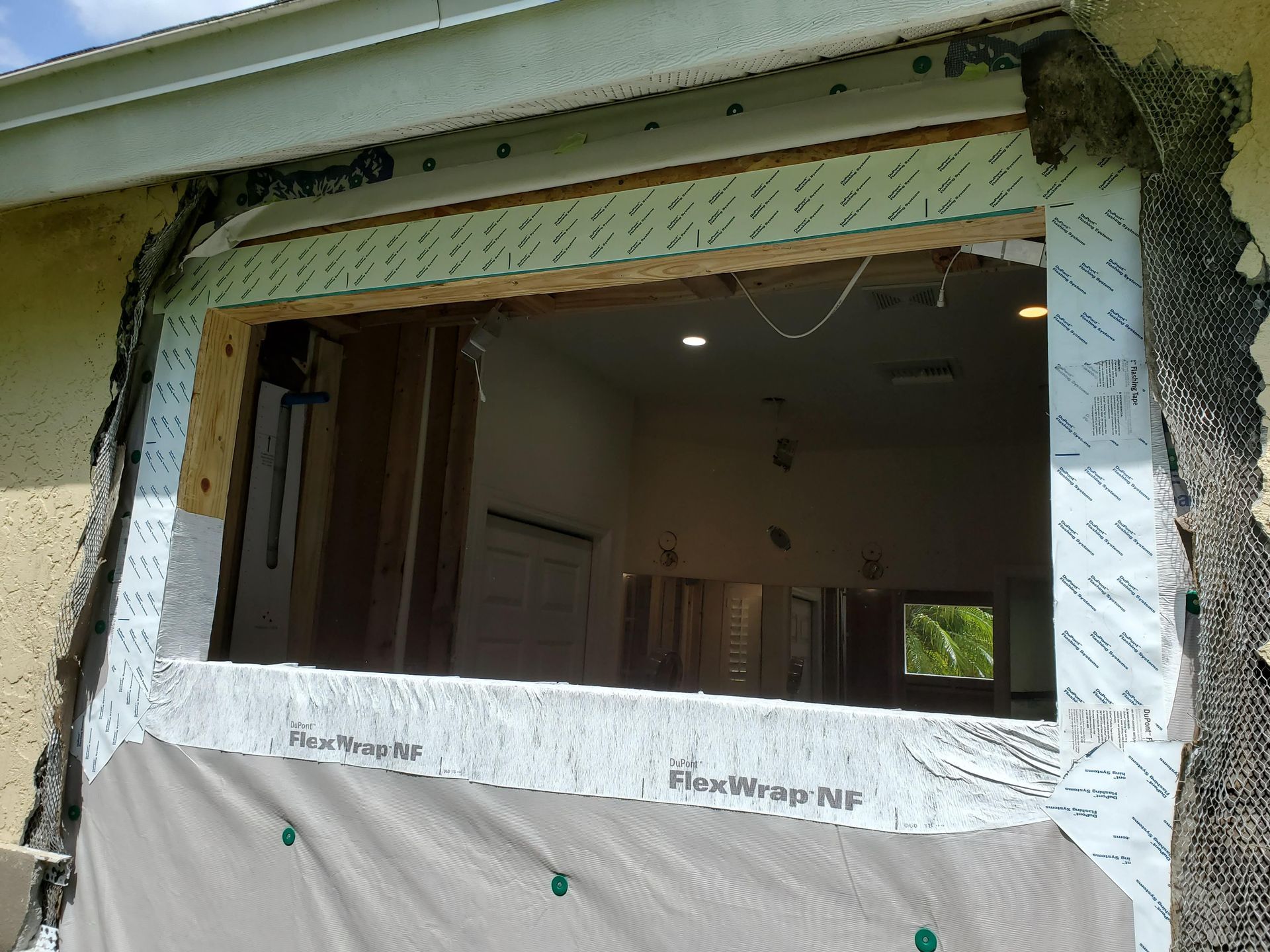 A window is being removed from a house and covered in styrofoam