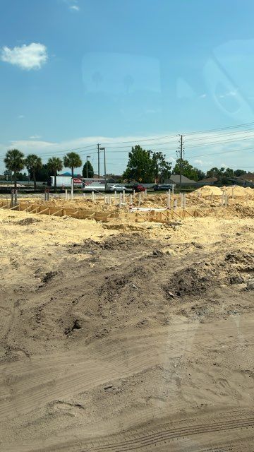 A large dirt field with a blue sky in the background.
