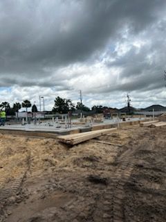 A construction site with a cloudy sky in the background.