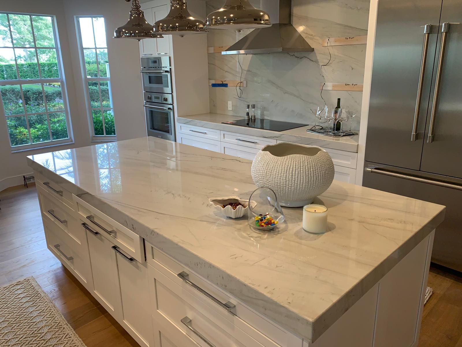 A kitchen with a large island in the middle of it.