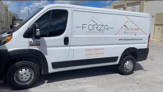 A white van with the word forza on the side is parked in a parking lot.