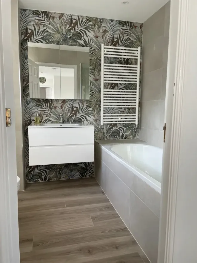 Bathroom with stunning floral accent tile wall and towel rails in our Ascot Bathroom and Tile showroom.