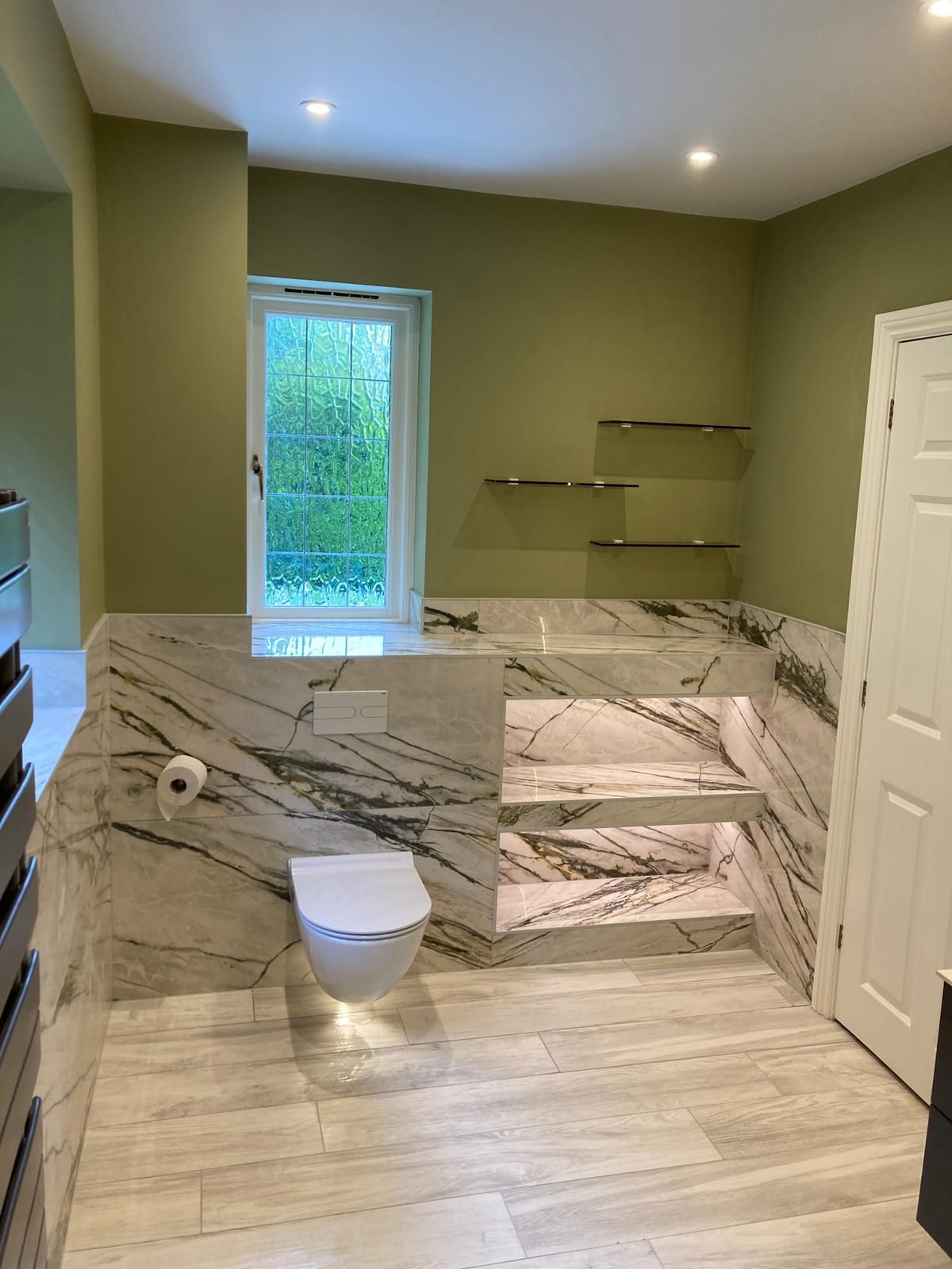 A modern bathroom renovation featuring large format tiles and LED lighting fitted by Options Bath and Tile Studio in Ascot.