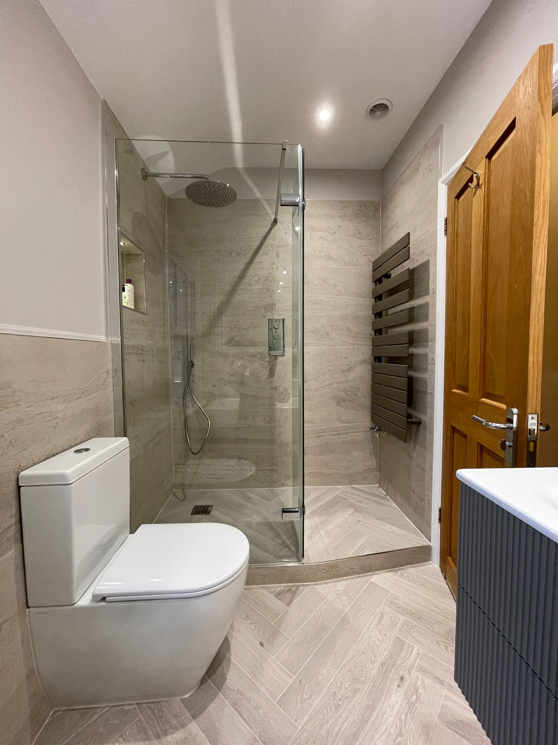 A luxury bathroom designed and installed by Options Bath and Tile studio in Ascot, Berkshire. Featuring mosaic tiles and wetroom styling.