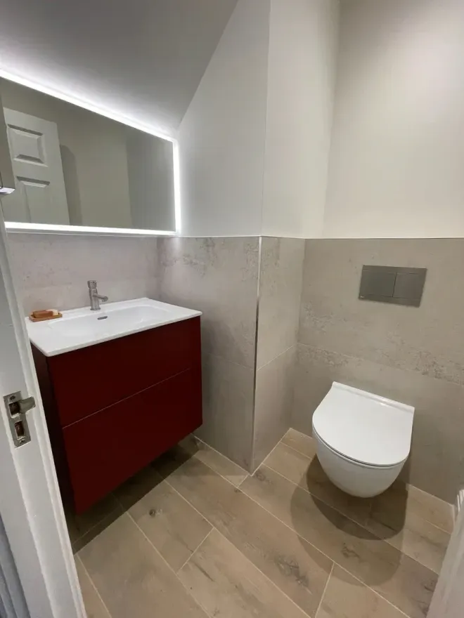 Stunning cloakroom bathroom with red accents and tiles designed and fitted by Options Bath and Tile Studio in Ascot, Berkshire.