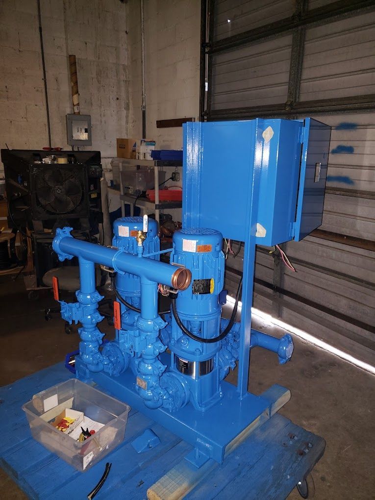A blue machine is sitting on top of a blue table in a garage.