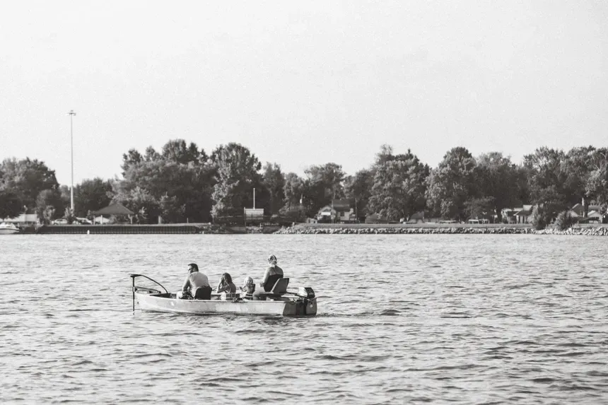 A black and white photo of a group of people in a boat on Buckeye Lake