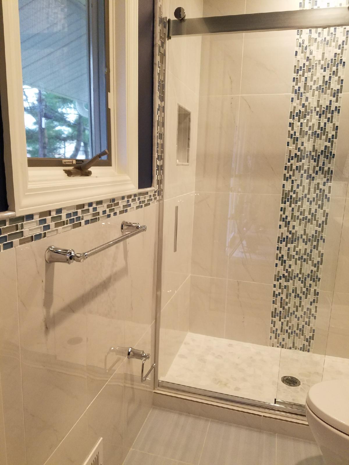 Standing shower remodel with blue, white and gray wall tiles