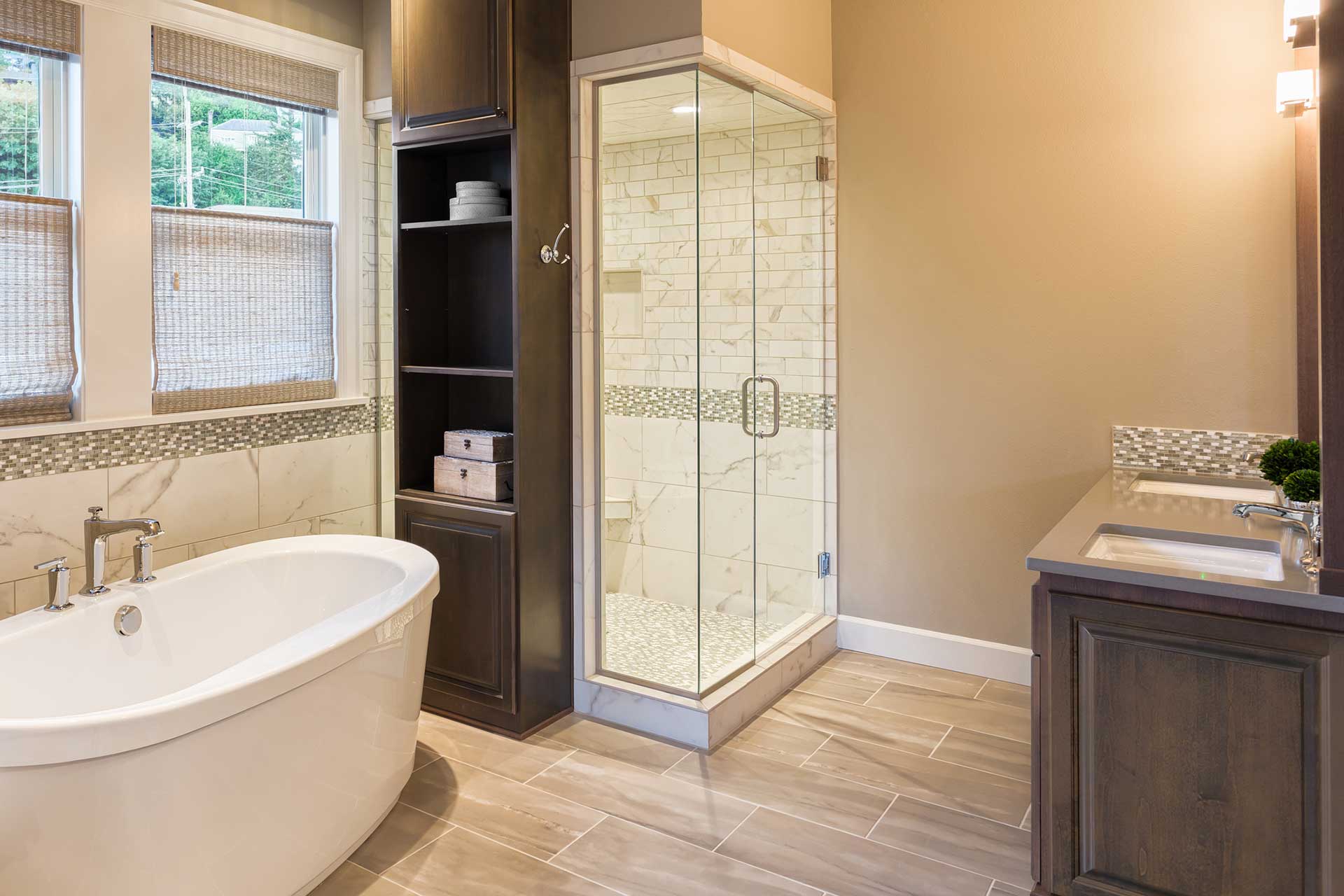 Bathroom remodel with white bathtub and hardwood floors from NTICE Designs Corp.