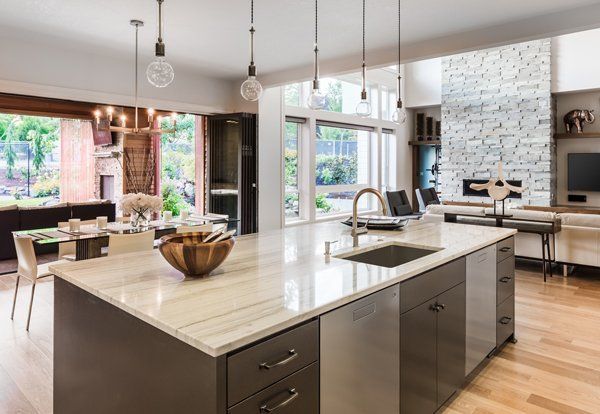 Large open kitchen with a full island and hardwood floors from NTICE Designs Corp.