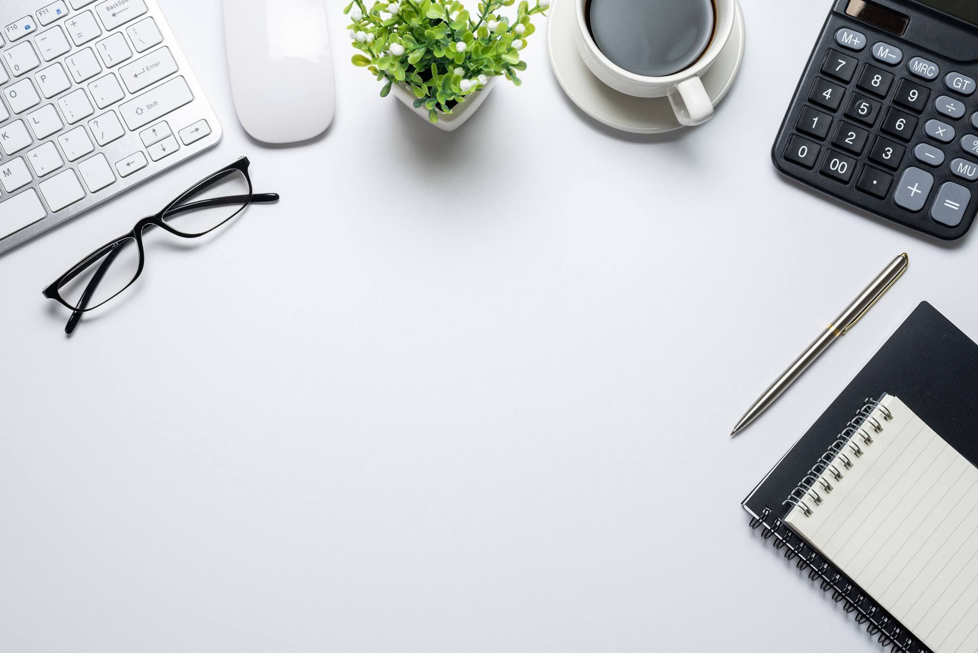 a desk with a calculator and a cup of coffee