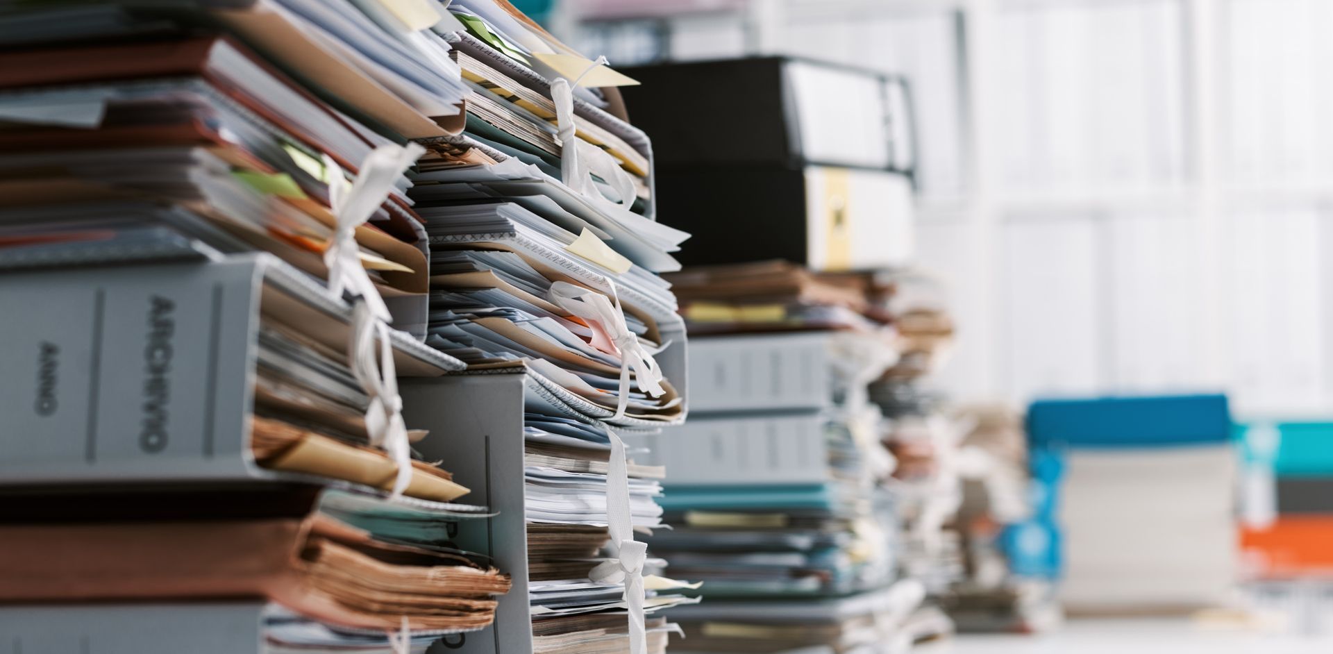 a stack of binders sitting on top of each other in an office .