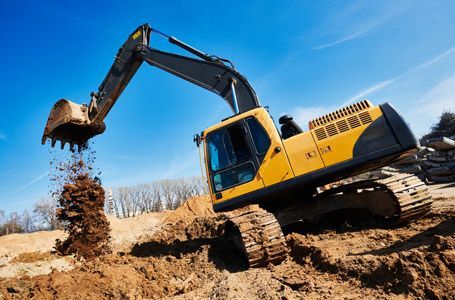 A Yellow Excavator is Digging a Hole in the Dirt on a Construction Site — JTM Projects Australia Pty Ltd in Moranbah, QLD