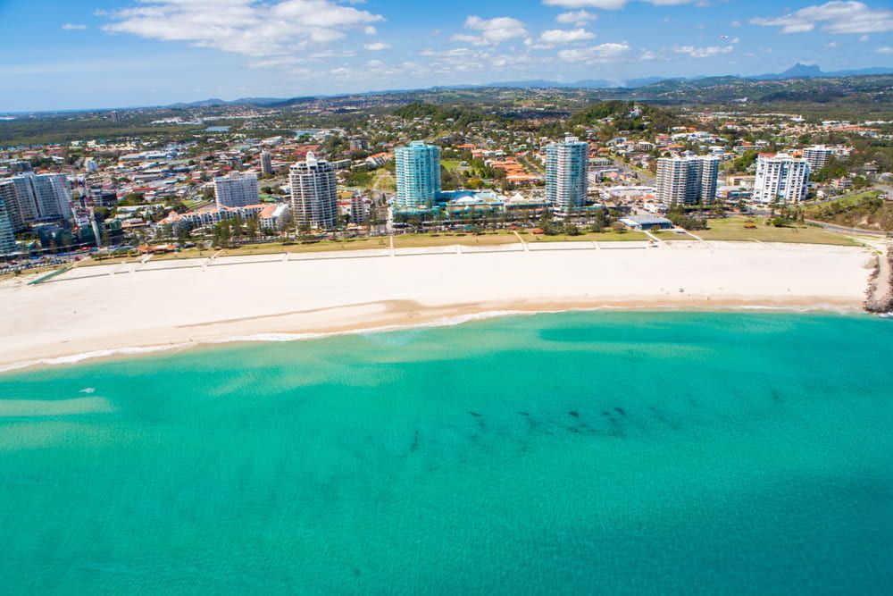 An Aerial View Of A Beach With A City In The Background — JTM Projects Australia Pty Ltd in Gold Coast, QLD