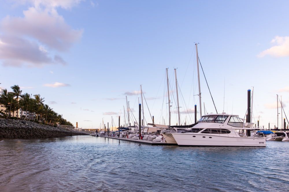 A Row Of Boats Are Docked In A Marina — JTM Projects Australia Pty Ltd in Mackay, QLD