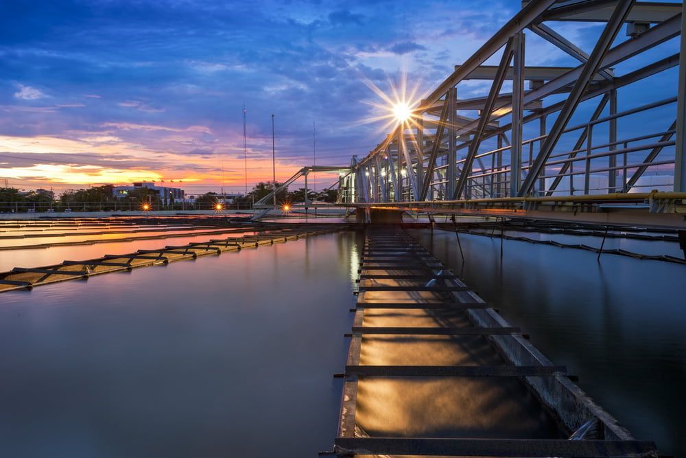 A Bridge Over A Body Of Water With A Sunset In The Background — JTM Projects Australia Pty Ltd in Blackwater, QLD