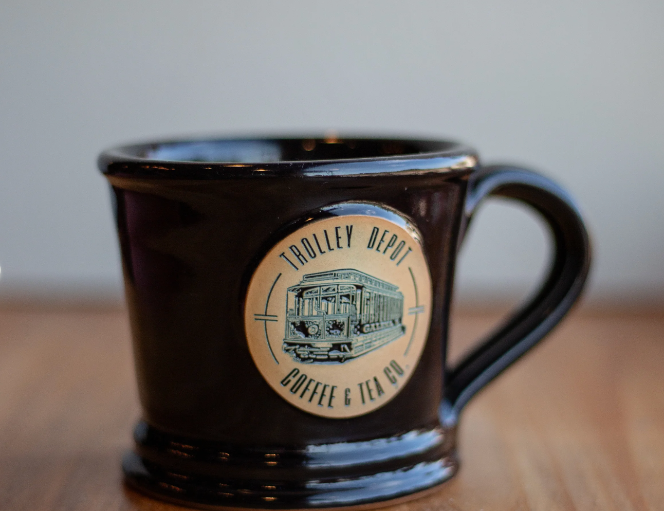 Two cups of coffee are being poured from a coffee machine