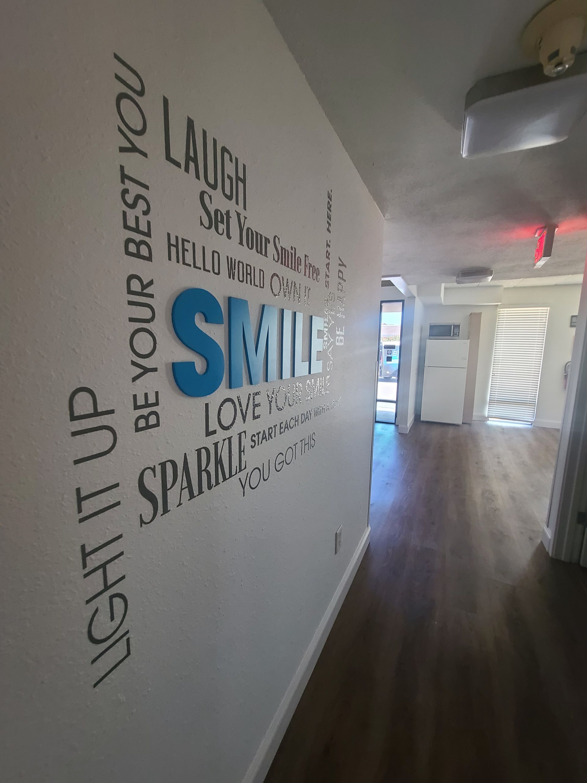 A hallway with a sign on the wall that says `` light it up be your best you ''