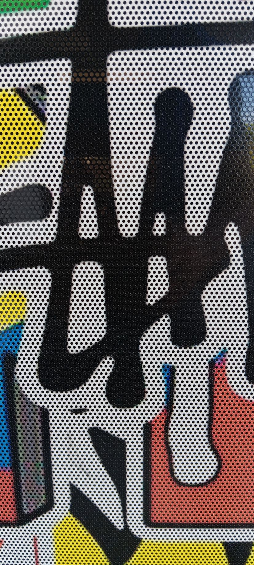 A close up of a colorful graffiti on a wall.