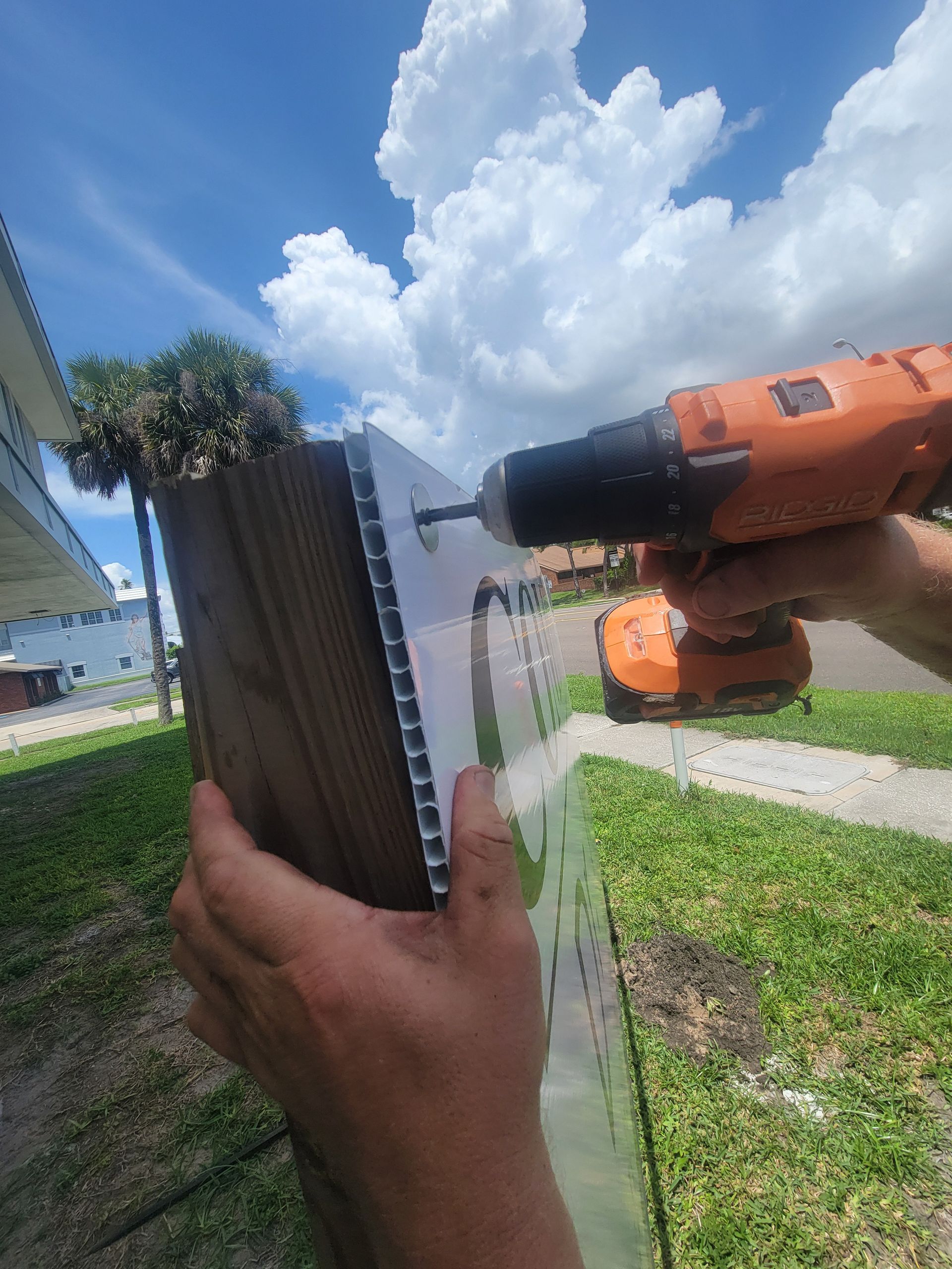 A person is using a drill to drill a hole in a piece of wood.