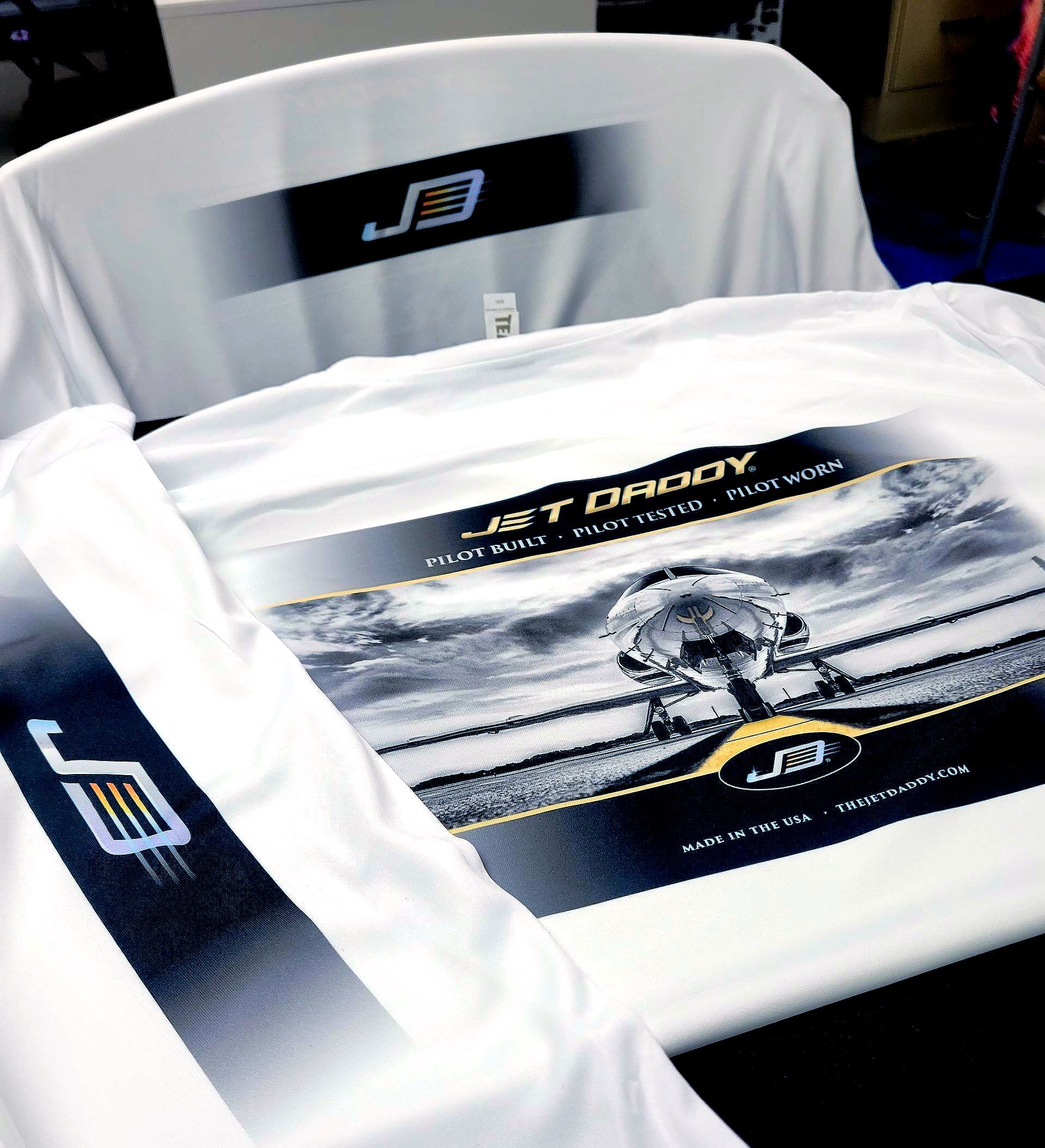 A white t-shirt with a picture of a jet on it titled jet daddy
