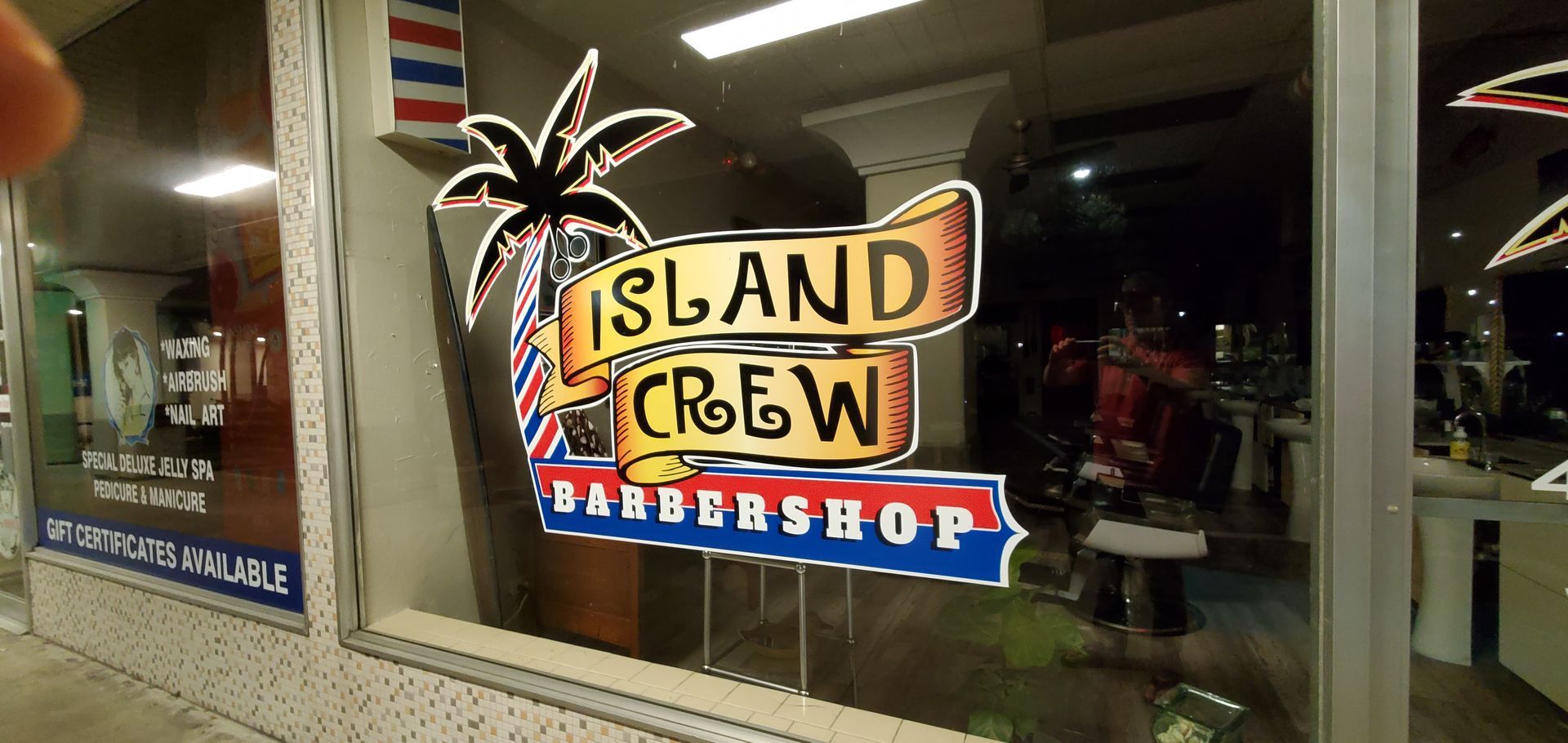 A barber shop with a sign that says island crew barber shop