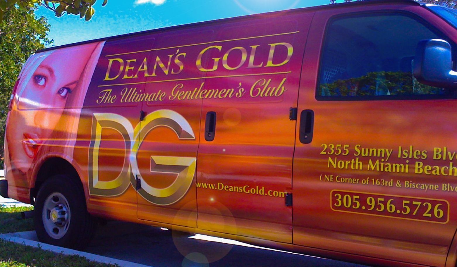 A deans gold van is parked on the side of the road