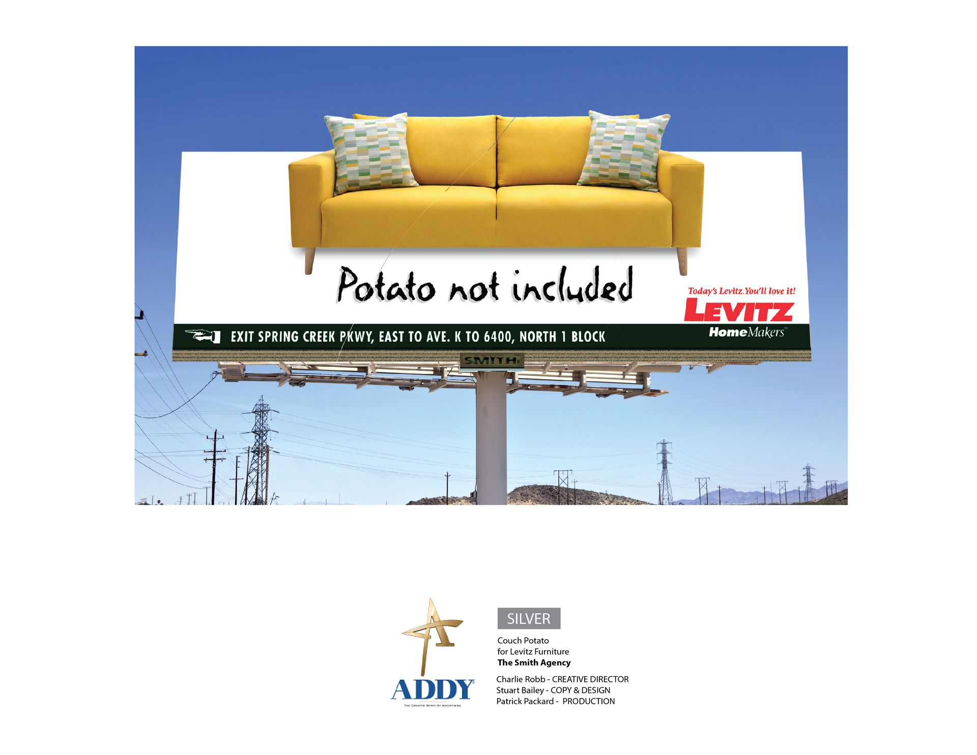 A billboard with a yellow couch on it that says potato not included