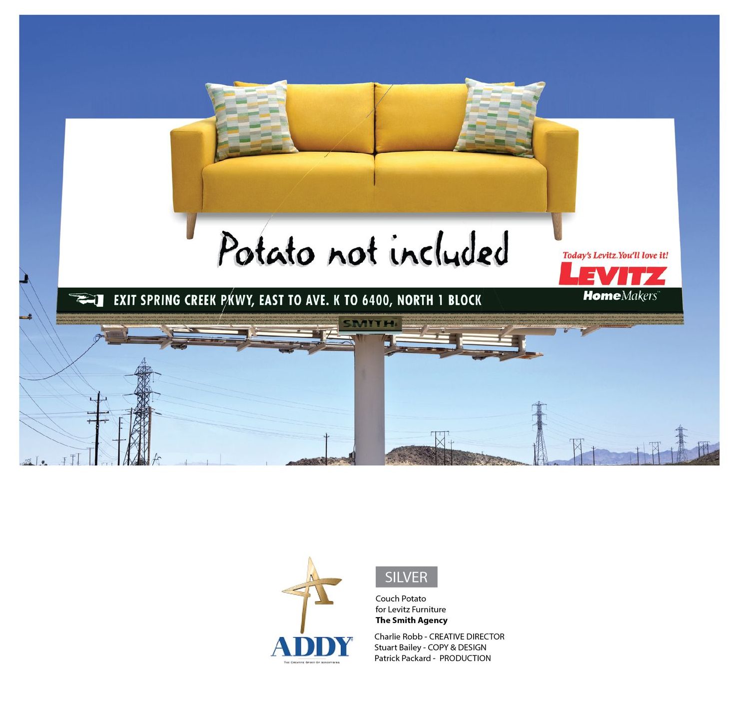 A billboard design for furniture store showing yellow couch that says potato not included and the gold addy award it won
