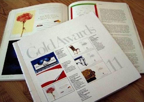 A book titled gold awards sits on a wooden table