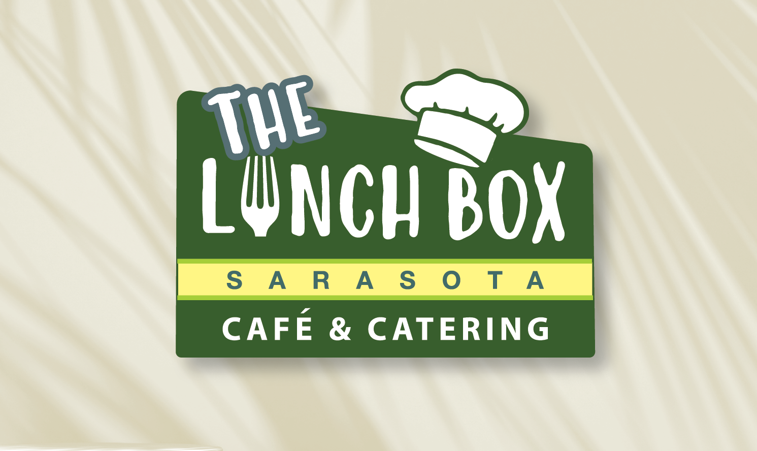 A logo for the lunch box cafe and catering