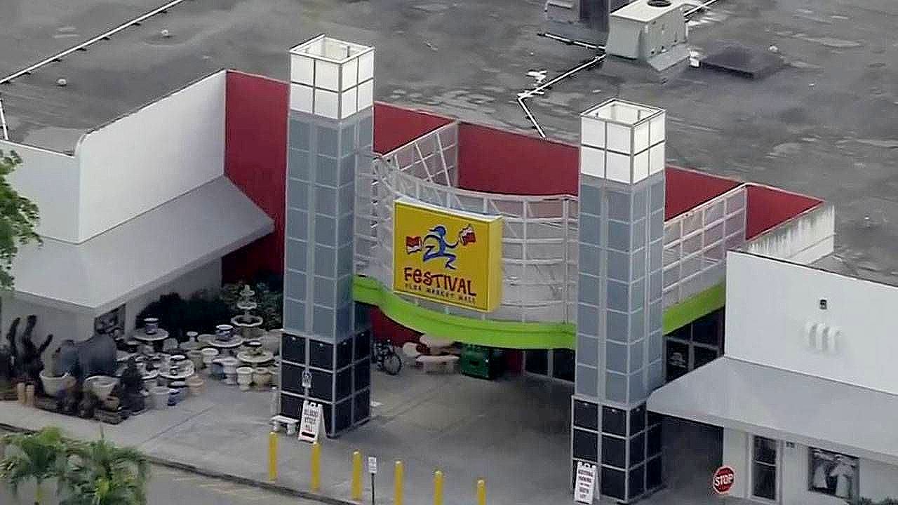 An aerial view of a building with a yellow sign that says payback