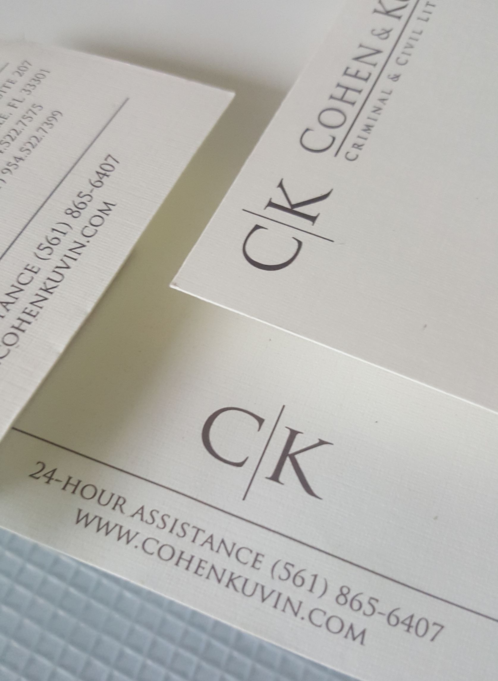 Two business cards with the letters ck on them