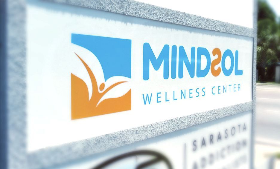 A sign for the mind2ol wellness center in sarasota