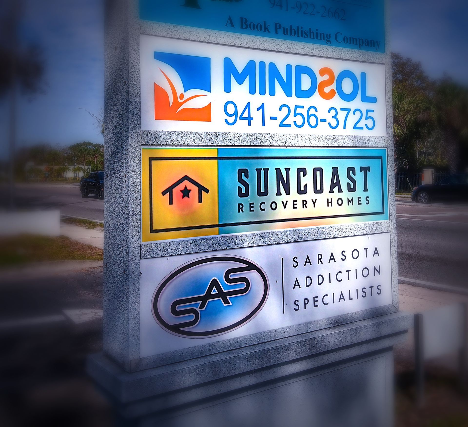 A sign for mind2ol and suncoast recovery homes