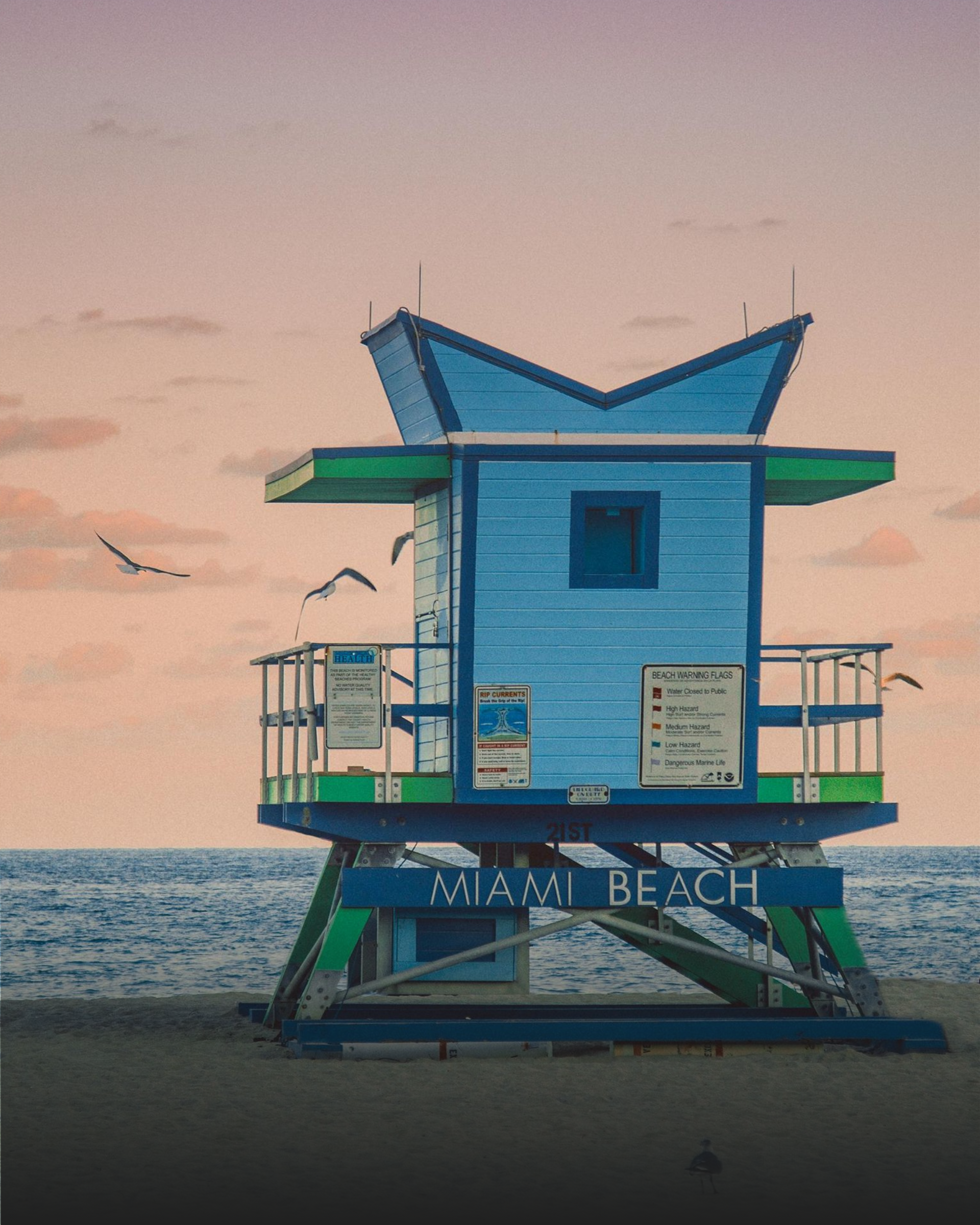 A blue and green lifeguard tower on miami beach