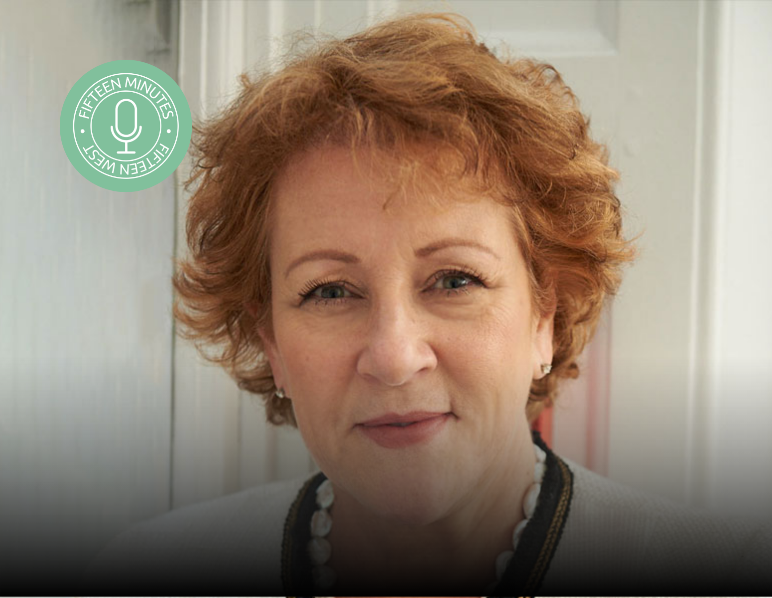 A close up of a woman 's face with a microphone sticker on her neck