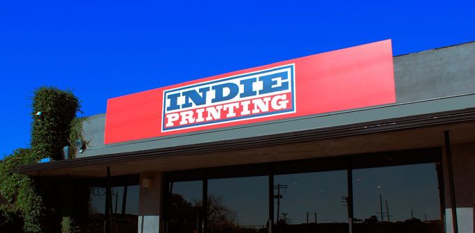A building with a red sign that says indie printing