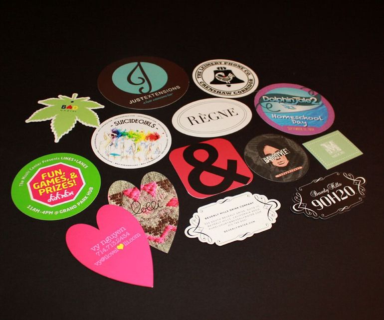 A bunch of stickers on a table including one that says renee