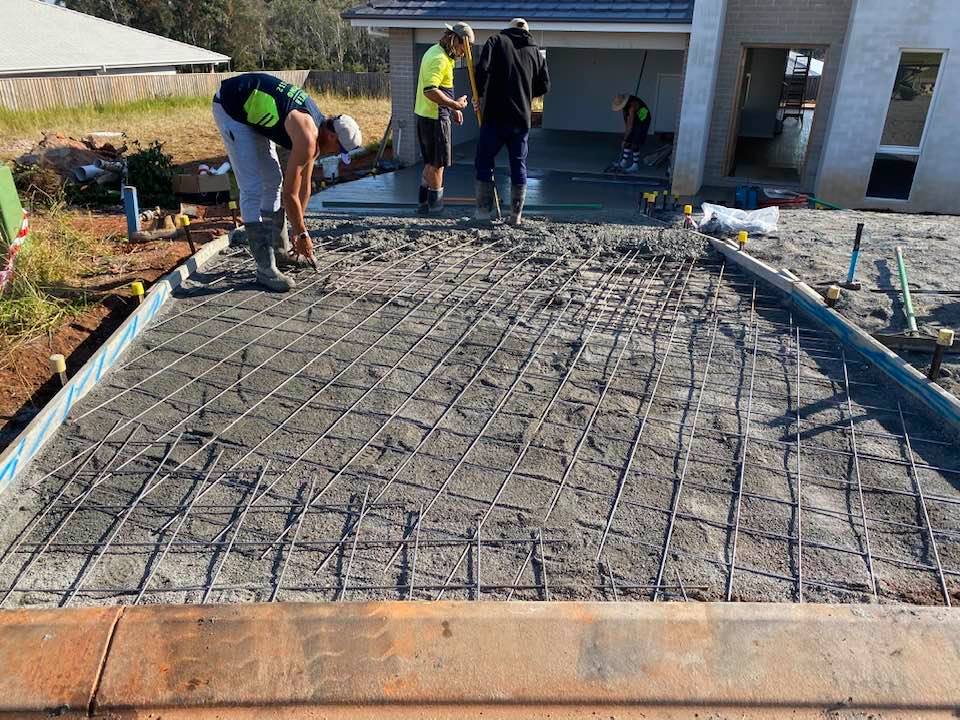 Three Worker Pouring Concrete On Driveway — Concreters in Port Macquarie, NSW