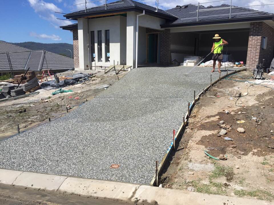 Man Pressure Wash The Driveway — Concreters in Port Macquarie, NSW