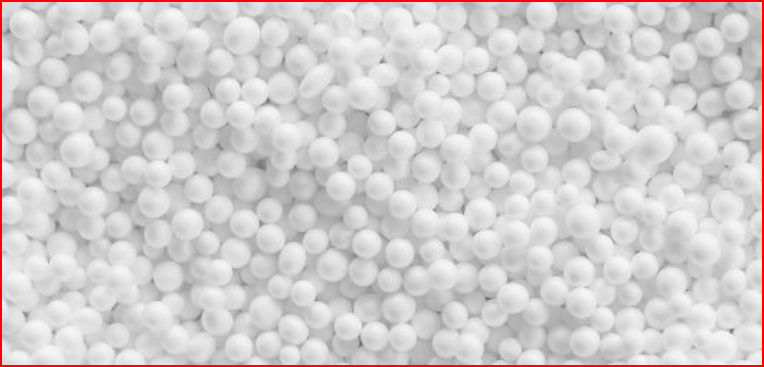 A pile of white styrofoam beads with a red border