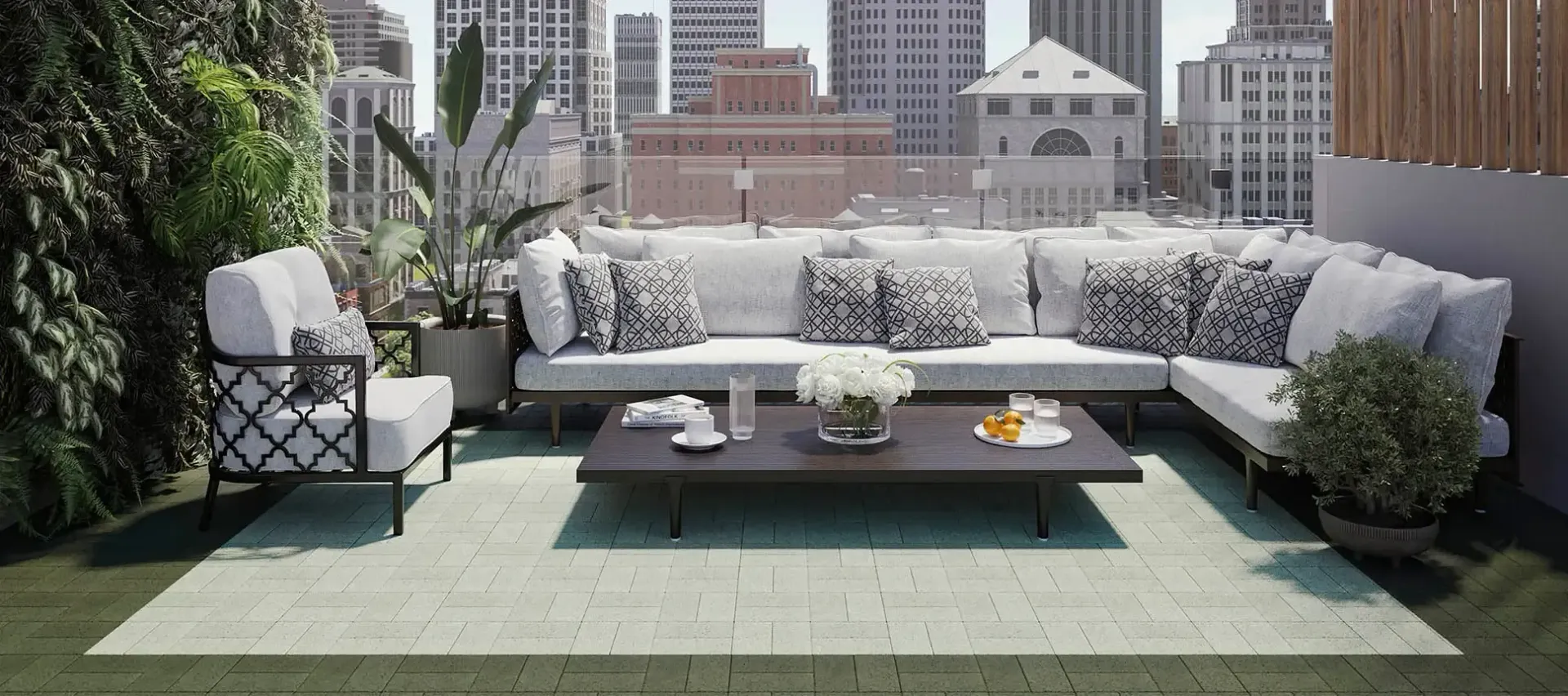 A patio with a couch , chairs , and a table with a view of the city.
