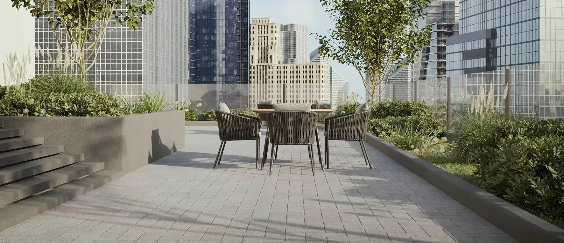 A patio with a table and chairs in front of a building.