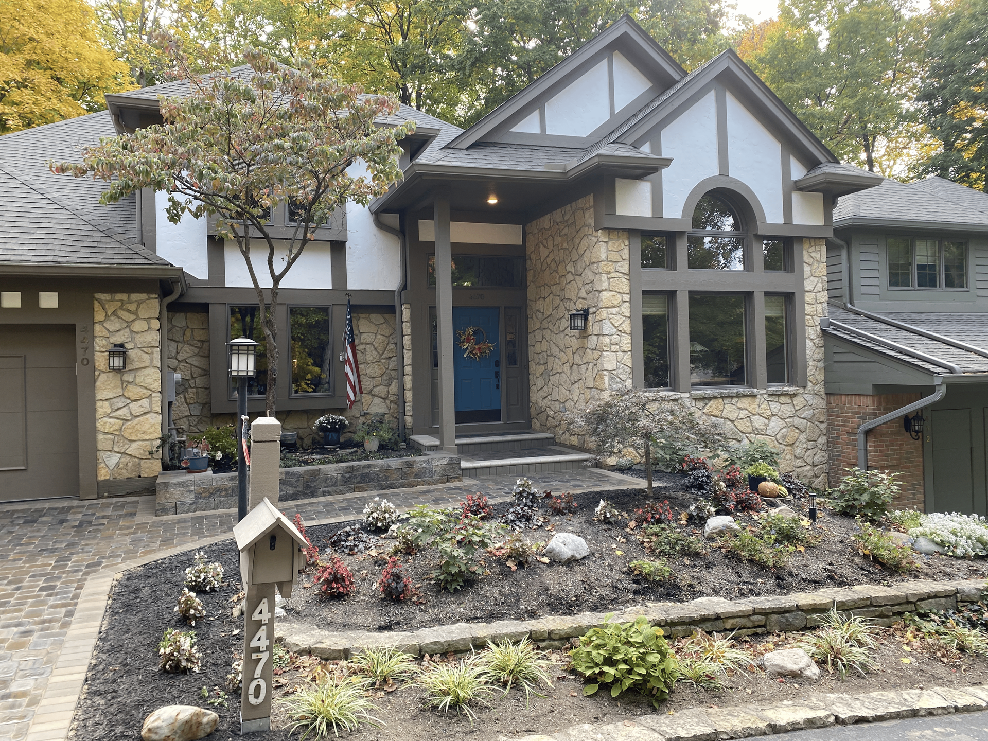 A house with a blue door and a mailbox in front of it