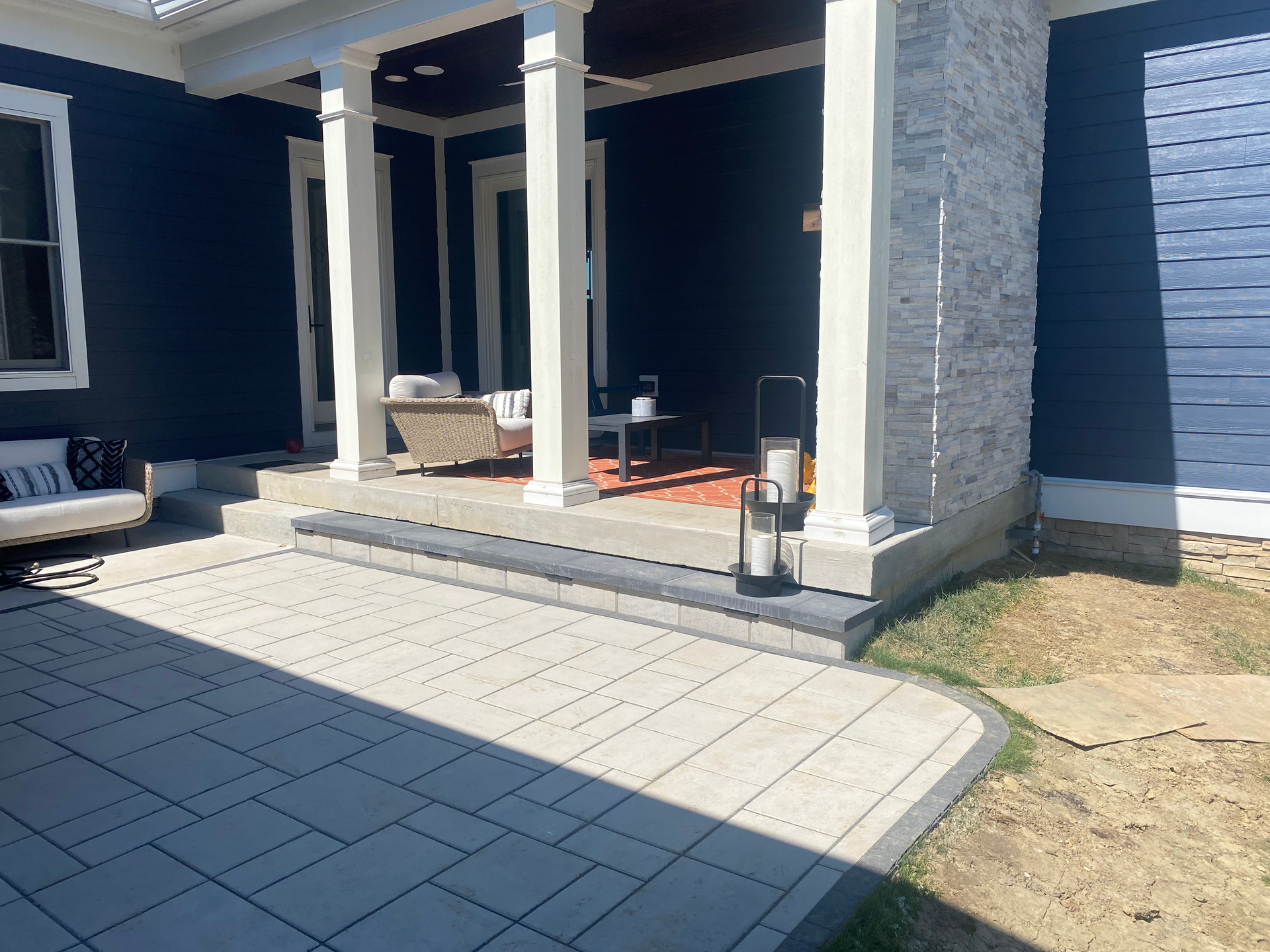 A blue house with a porch and a patio