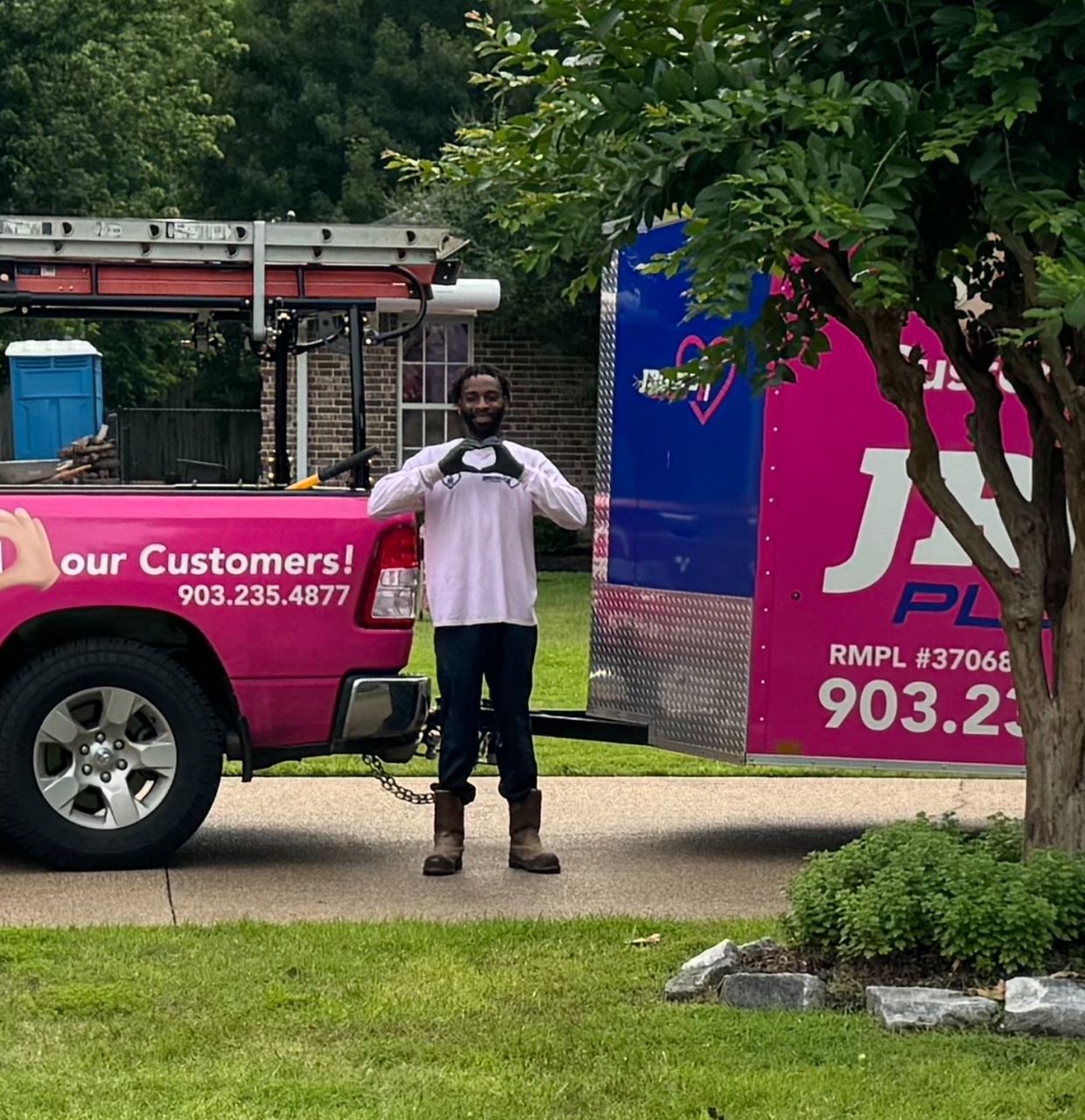 A man standing in front of a truck that says our customers