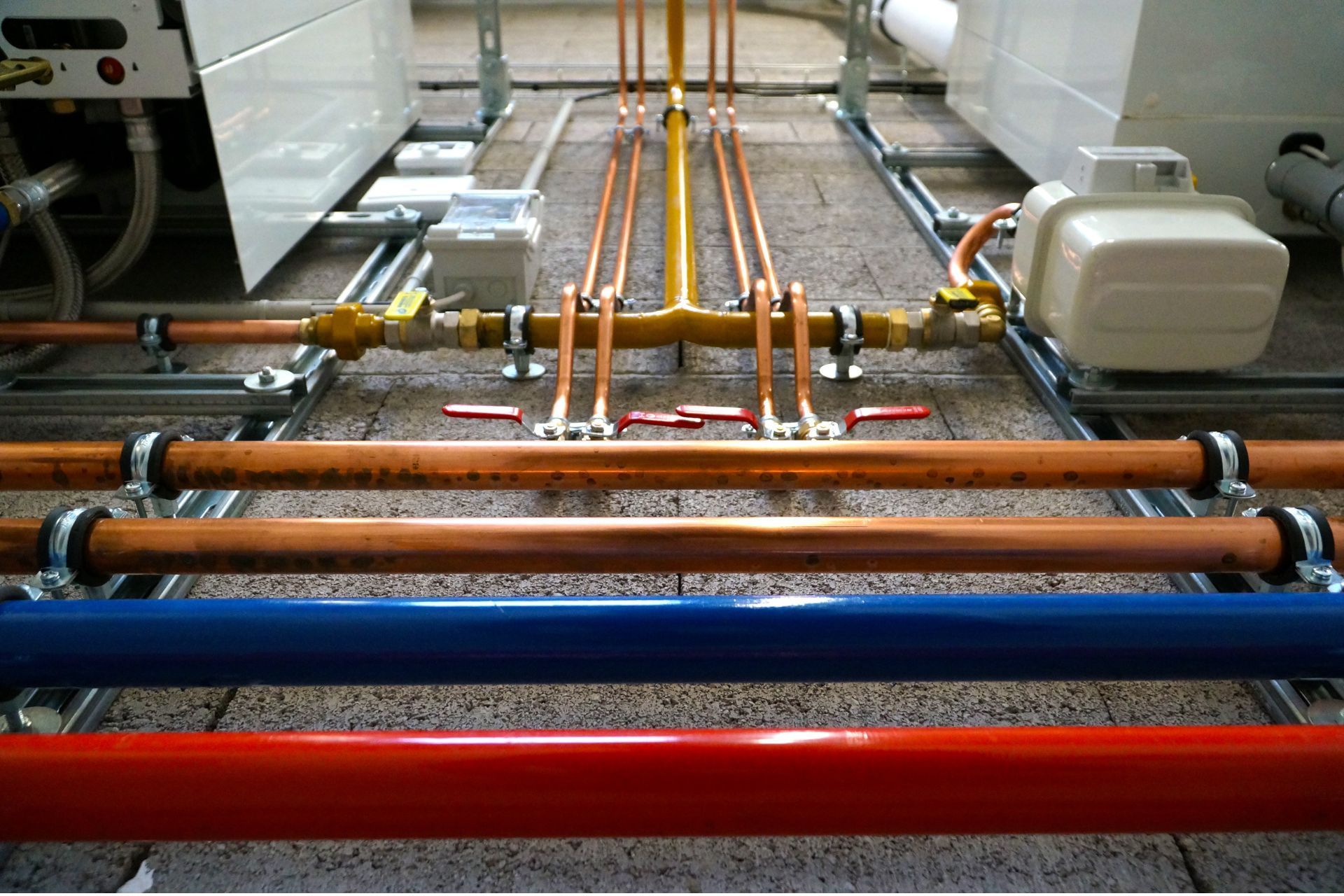 A bunch of pipes are lined up on the floor