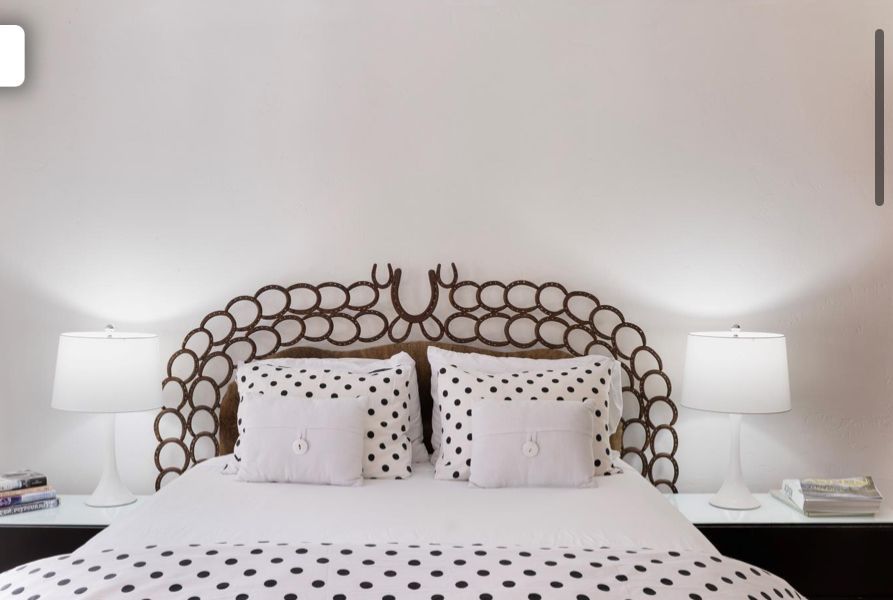 Studio apartment with bed, sofa, kitchen, and large windows.